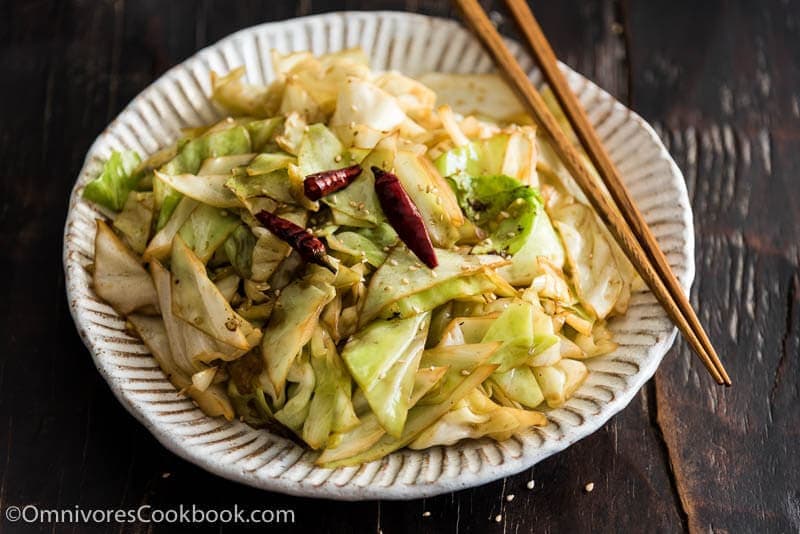 Infuse the oil with aromatics and then toss at a high heat, this adds a smoky flavor to the sweet fried cabbage and makes a quick and delicious side dish.