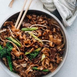 This beef chow fun is loaded with fat noodles, tender steak, and crisp veggies. Even better, now you can cook restaurant-style fried noodles in your home kitchen with a flat skillet! {Gluten-Free Adaptable}