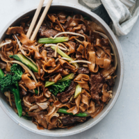 This beef chow fun is loaded with fat noodles, tender steak, and crisp veggies. Even better, now you can cook restaurant-style fried noodles in your home kitchen with a flat skillet! {Gluten-Free Adaptable}