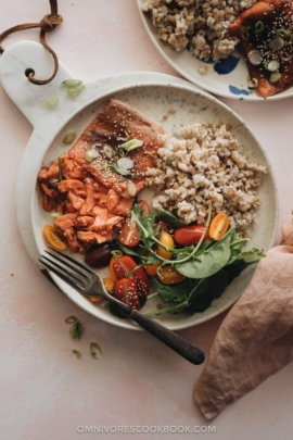 Moist flaky sous-vide salmon with Asian sauce served with brown rice and salad