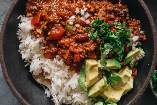 Chinese served over steamed rice with avocado and cilantro