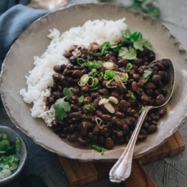 Black beans with rice garnished with cilantro and green onions