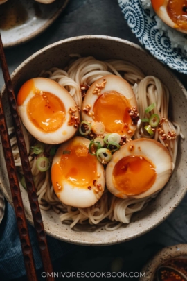 Marinated eggs on noodles with chili oil close-up