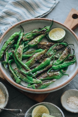 Charred shishito peppers in a bowl