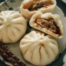 Fluffy steamed buns filled with juicy pork and Chinese chive