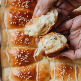 Breaking apart a coconut bun