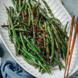 This quick and easy Chinese garlic green beans recipe uses a few ingredients to achieve maximum flavor and a perfect texture! The green beans are pan fried until blistered and tender, then stir fried with garlic and ginger to lend a great aroma. Serve this as a side dish to complete your dinner or over steamed rice as a light lunch. {Vegan, Gluten-Free adaptable}