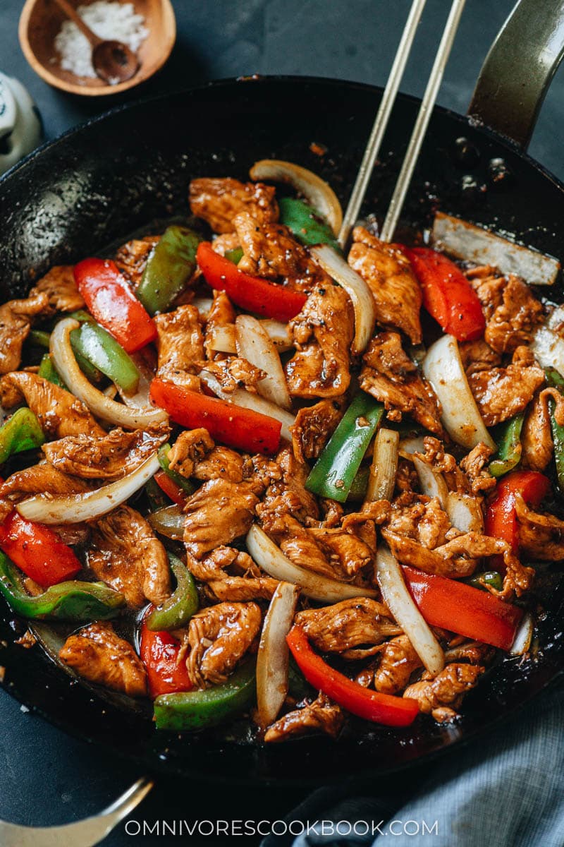 Black pepper chicken served in plates with rice on the side