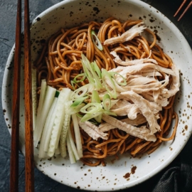 Chinese chicken noodle salad garnished with cucumber