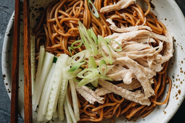 Chinese chicken noodle salad garnished with cucumber