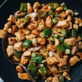 Cashew chicken served in a plate close up