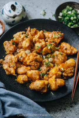 Homemade orange chicken garnished with green onion