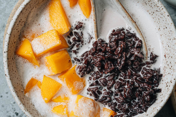 Black rice pudding with coconut milk close up