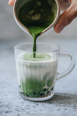 Pouring matcha to make matcha bubble tea